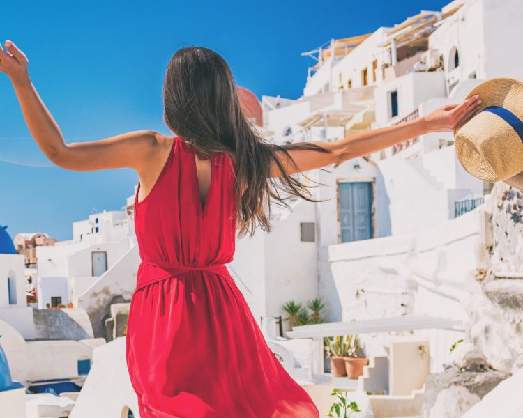 Europe travel vacation fun summer woman feeling free dancing with arms open in freedom at Oia, Santorini, Greece island. Carefree girl tourist banner panorama. Europe travel vacation fun summer woman feeling free dancing with arms open in freedom at Oia, Santorini, Greece island. Carefree girl tourist banner panorama.